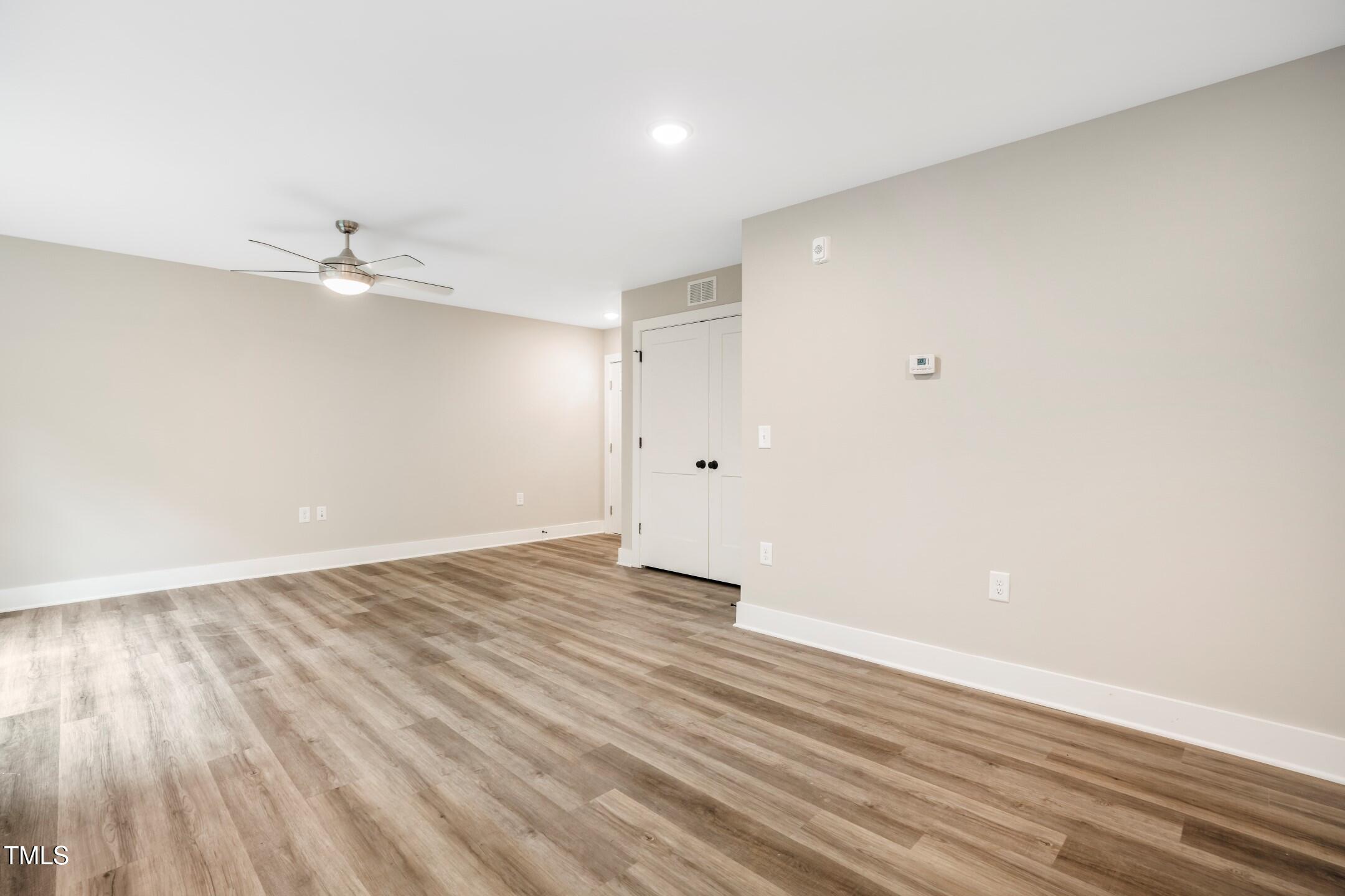 303 Linwood Street, Unit 306 Apex, NC 27502 - Photo 13 of 19 a view of an empty room with wooden floor