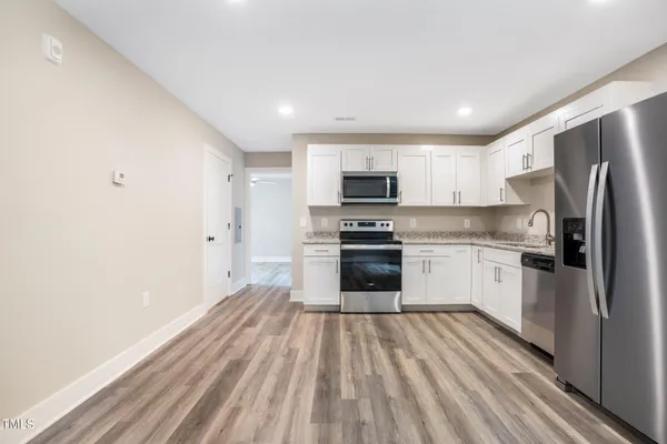 a kitchen with stove cabinets and refrigerator