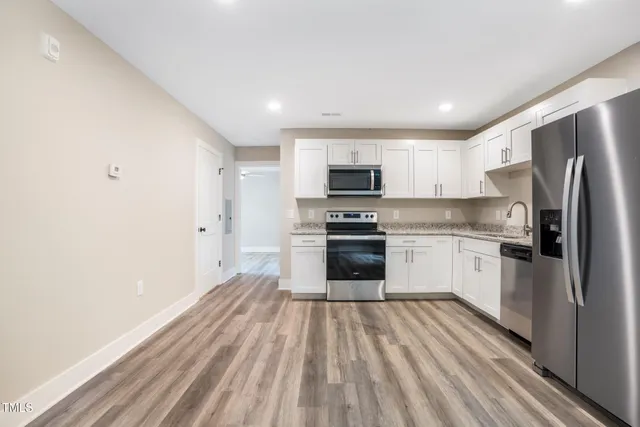a kitchen with stove cabinets and refrigerator