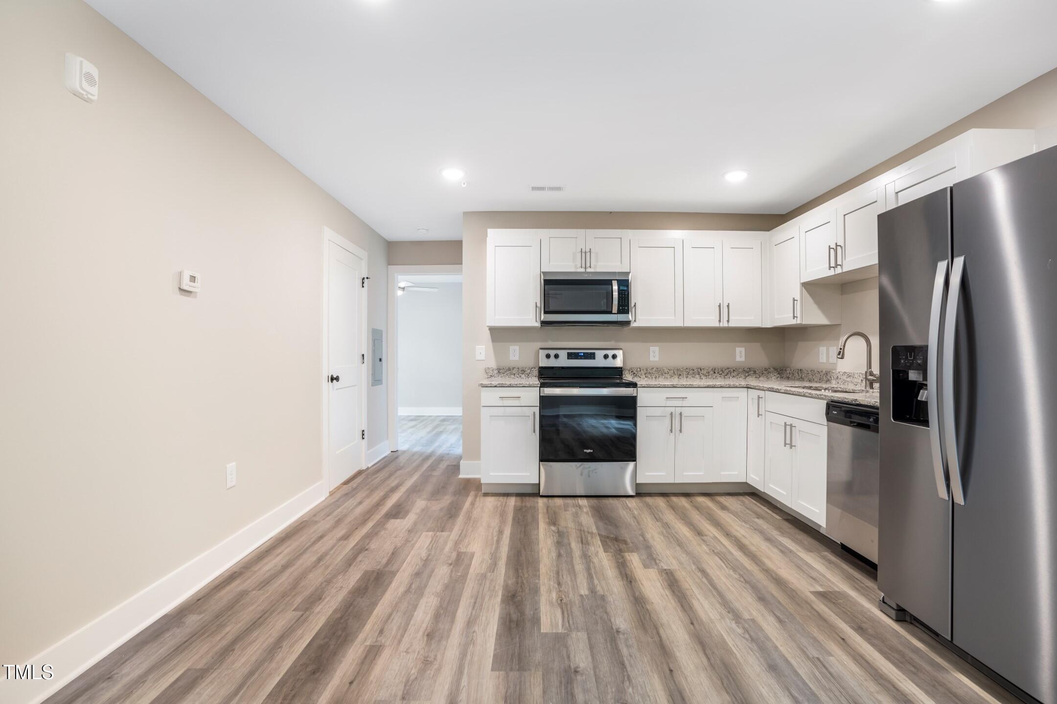 303 Linwood Street, Unit 306 Apex, NC 27502 - Photo 3 of 19 a kitchen with stove cabinets and refrigerator