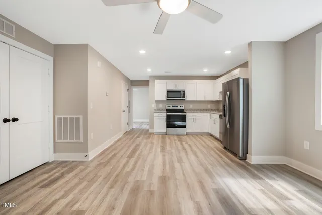a view of kitchen with wooden floor electronic appliances and window