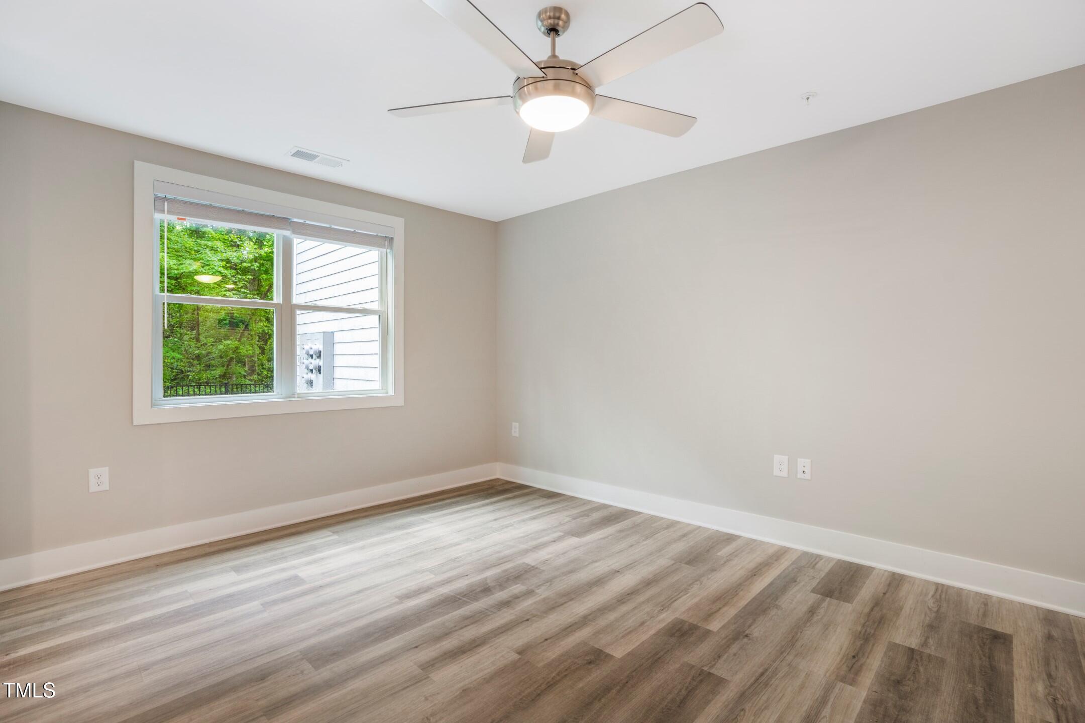 303 Linwood Street, Unit 306 Apex, NC 27502 - Photo 7 of 19 an empty room with a window and a fan