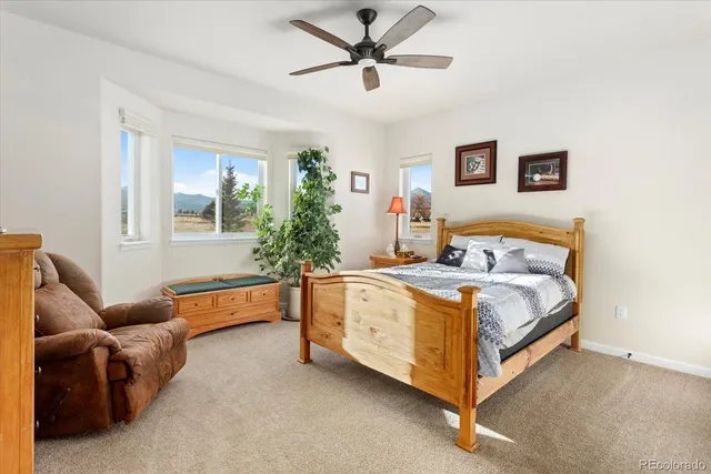 a bedroom with a bed couch and window