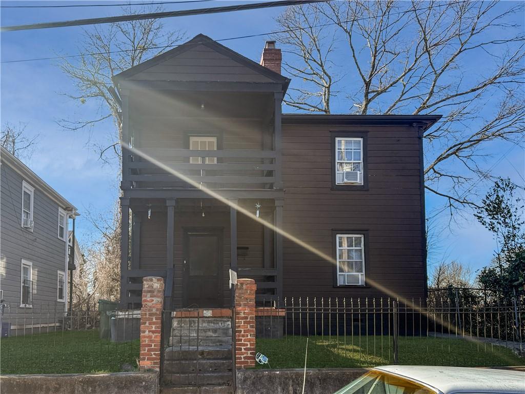 a front view of a house with glass windows and a yard