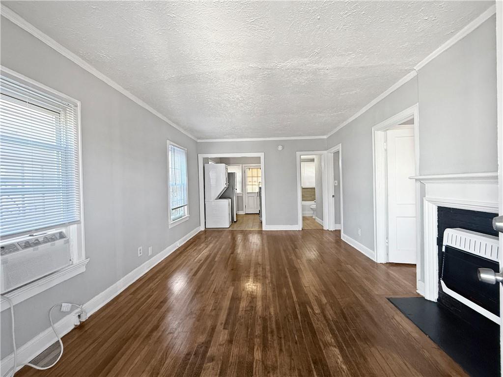 109 Vine Street Southwest, Unit A Atlanta, GA 30314 - Photo 3 of 14 a view of an empty room with wooden floor and a window