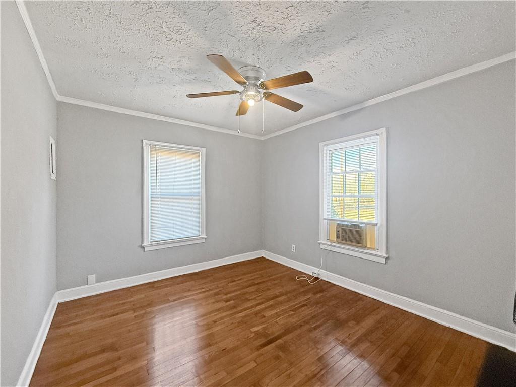 109 Vine Street Southwest, Unit A Atlanta, GA 30314 - Photo 4 of 14 an empty room with windows and fan