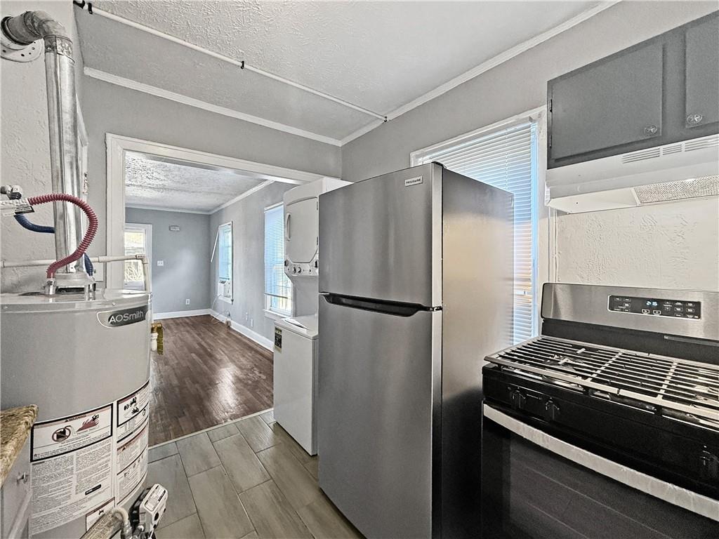 109 Vine Street Southwest, Unit A Atlanta, GA 30314 - Photo 10 of 14 a kitchen with a refrigerator and a stove
