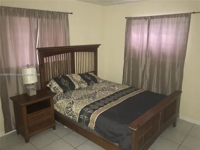 a bed sitting in a balcony next to a window