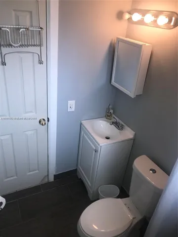 a white toilet sitting next to a bathroom sink