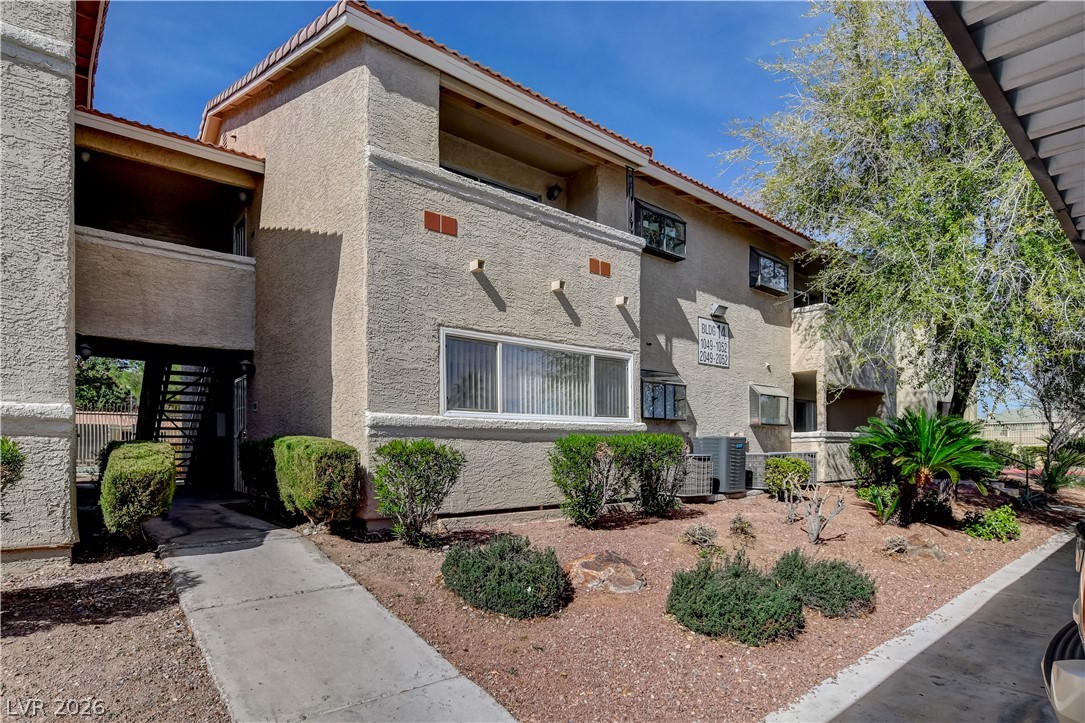 7200 West Pirates Cove Road, Unit 1050 Las Vegas, NV 89145 - Photo 1 of 24 View of apartment building / complex featuring stairs