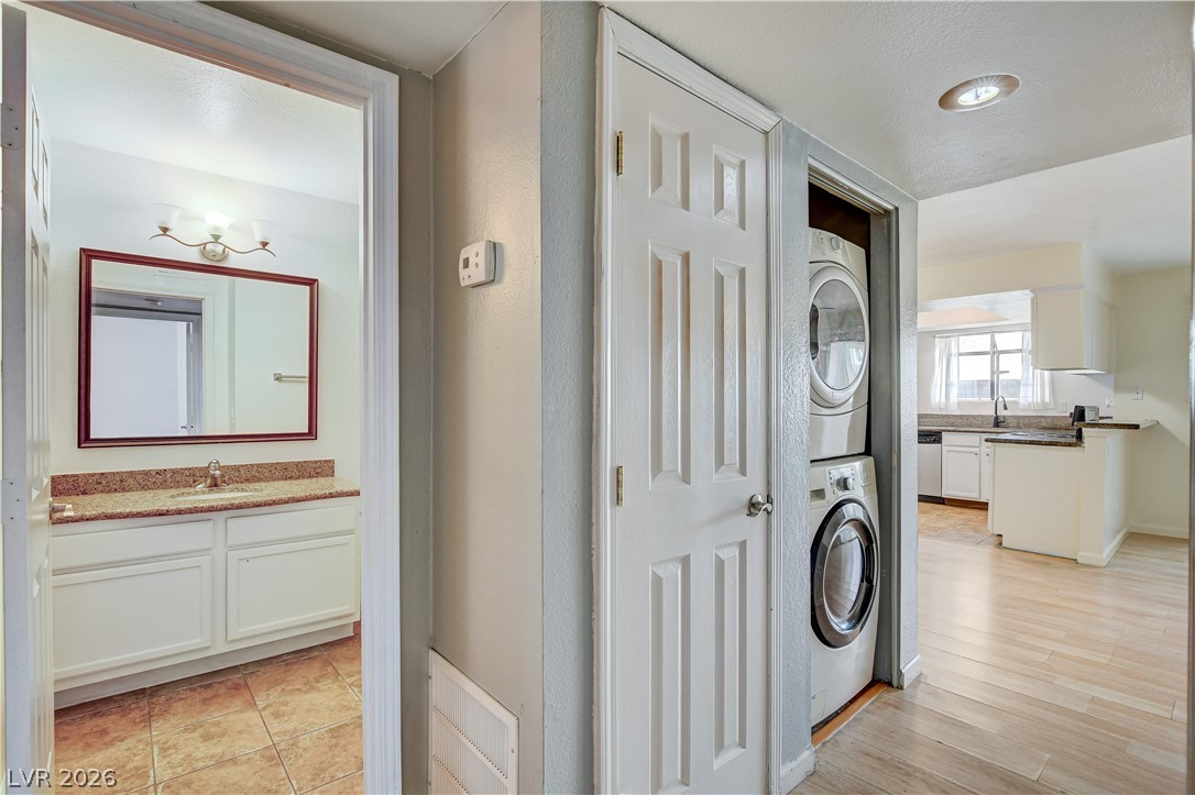 7200 West Pirates Cove Road, Unit 1050 Las Vegas, NV 89145 - Photo 12 of 24 Laundry area featuring stacked washer and clothes dryer