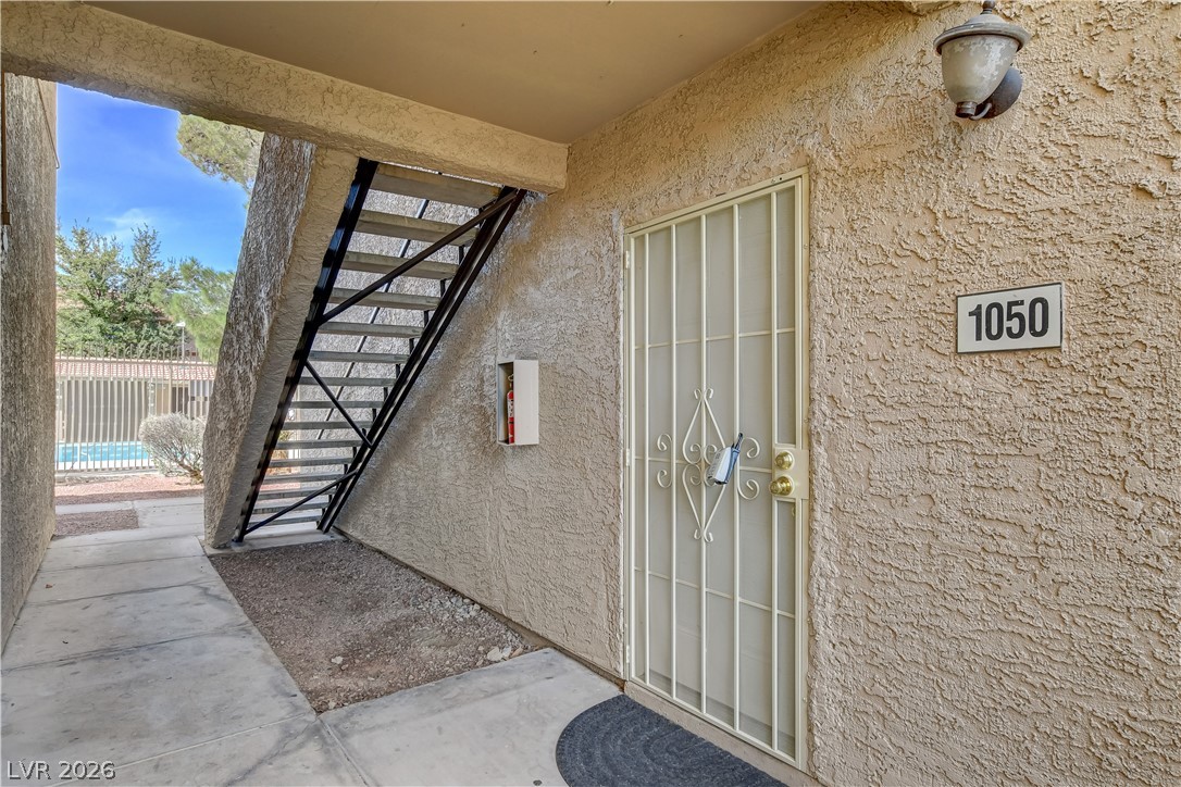 7200 West Pirates Cove Road, Unit 1050 Las Vegas, NV 89145 - Photo 2 of 24 View of exterior entry featuring stucco siding