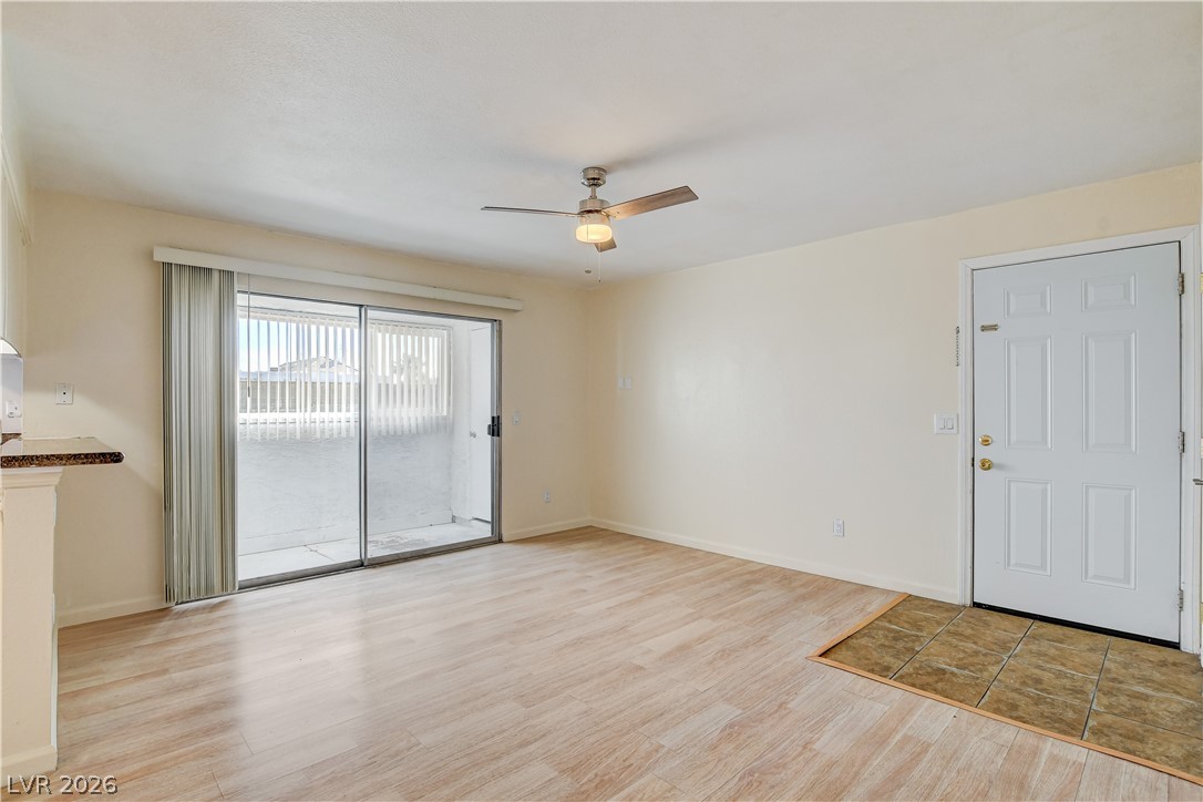 7200 West Pirates Cove Road, Unit 1050 Las Vegas, NV 89145 - Photo 4 of 24 Unfurnished room featuring a ceiling fan and light wood finished floors