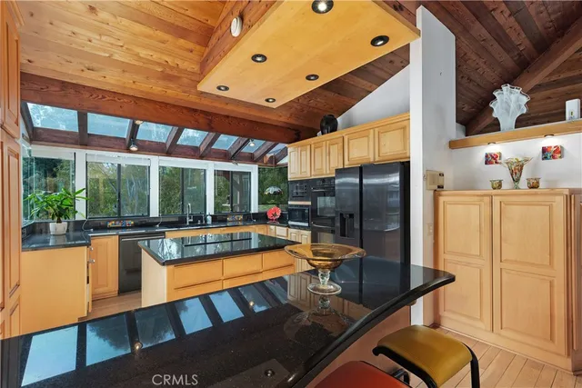 a view of staircase with lots of frames on wall and a window