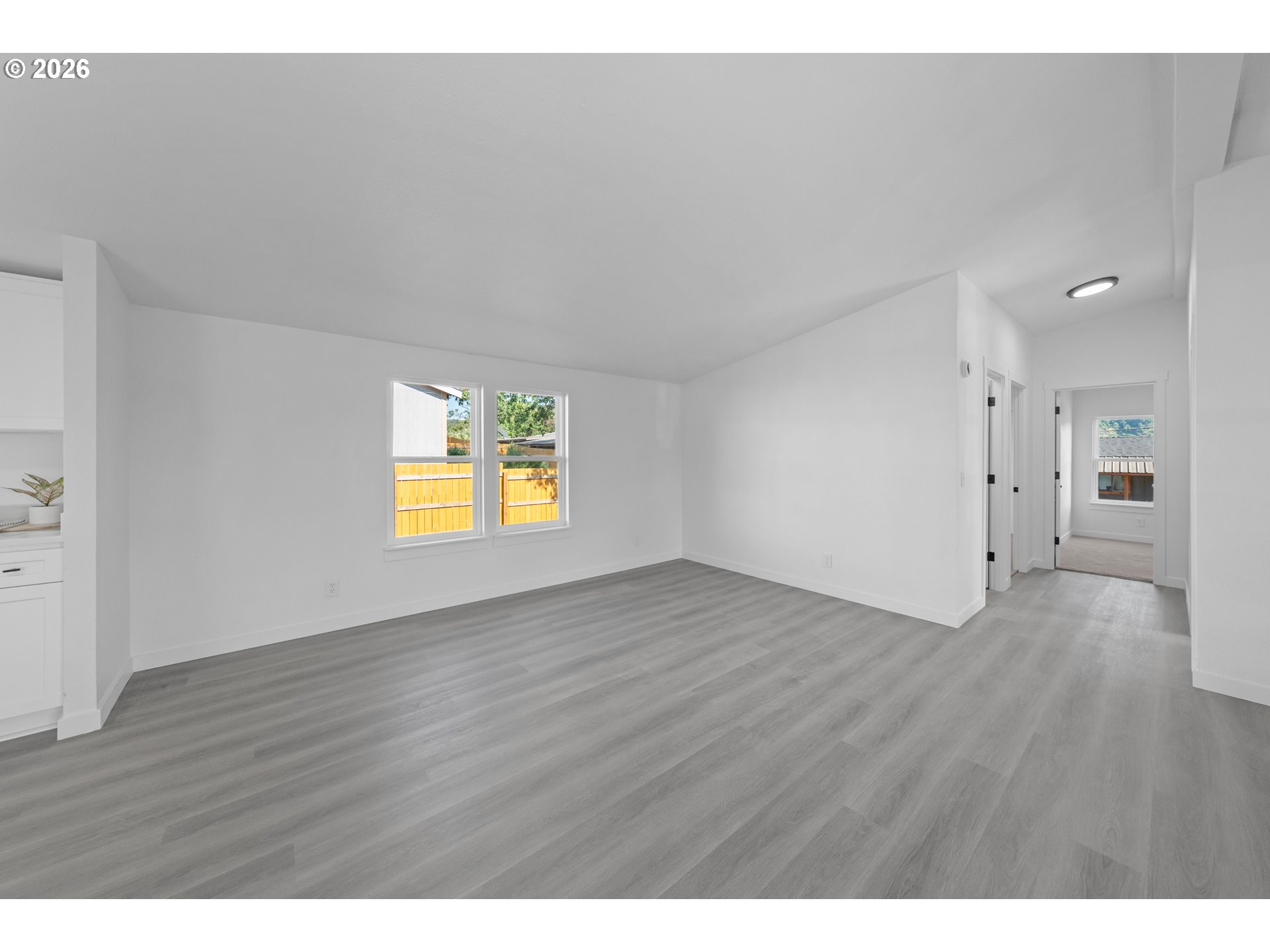 70 Darrell Avenue Winston, OR 97496 - Photo 8 of 39 a view of an empty room with wooden floor and a window