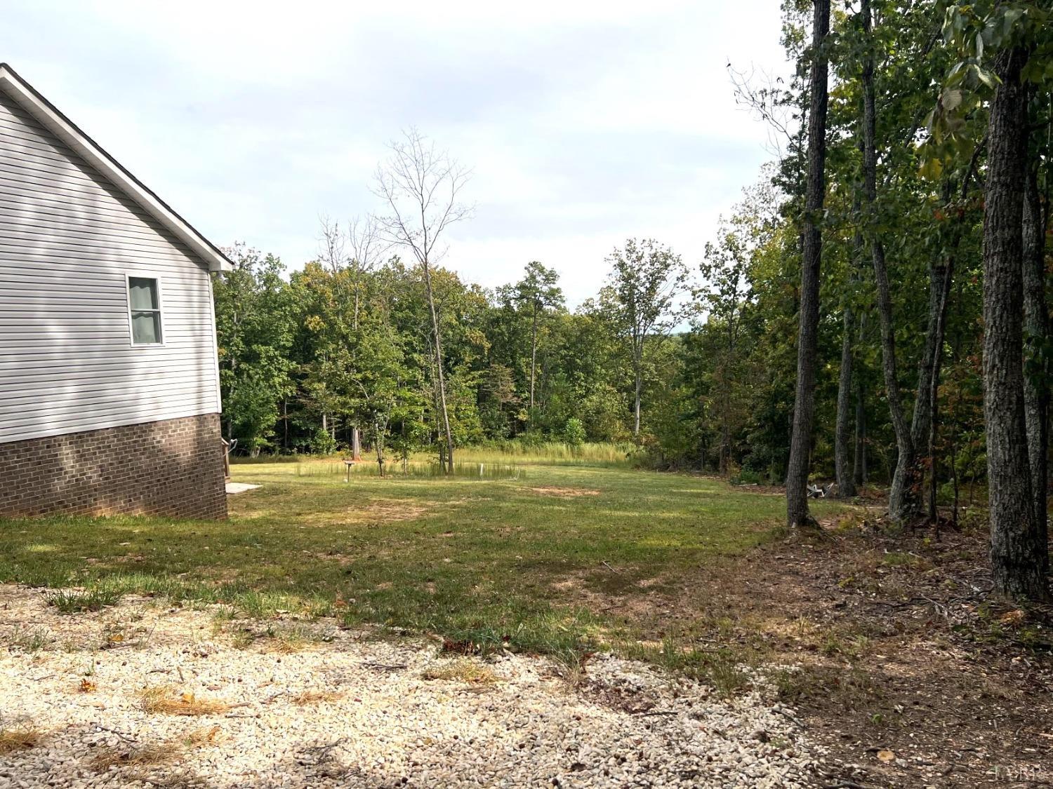 1226 Mountain Cut Road Appomattox, VA 24522 - Photo 20 of 22 a backyard of a house with lots of green space