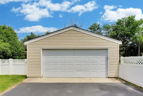 a view of a house with a patio and a yard