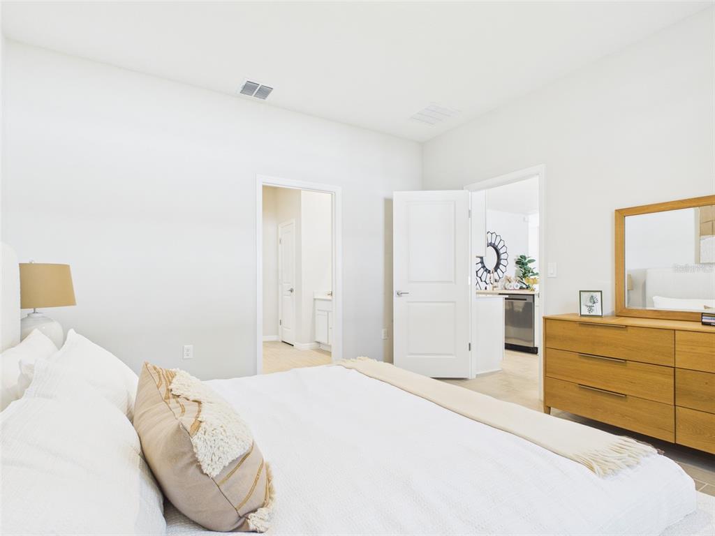 7110 Southwest 133rd Lane Ocala, FL 34473 - Photo 23 of 38 a bedroom with a bed and a dresser