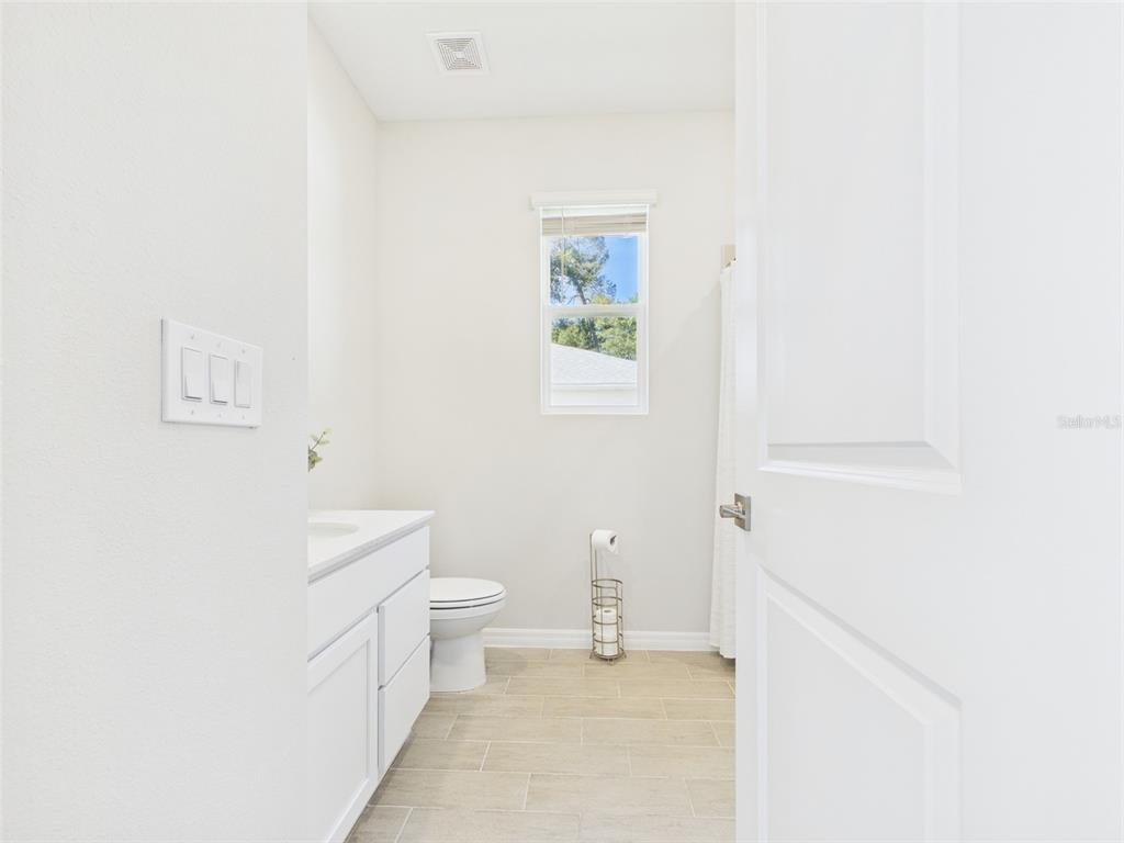 7110 Southwest 133rd Lane Ocala, FL 34473 - Photo 30 of 38 a bathroom with a sink a toilet and a window