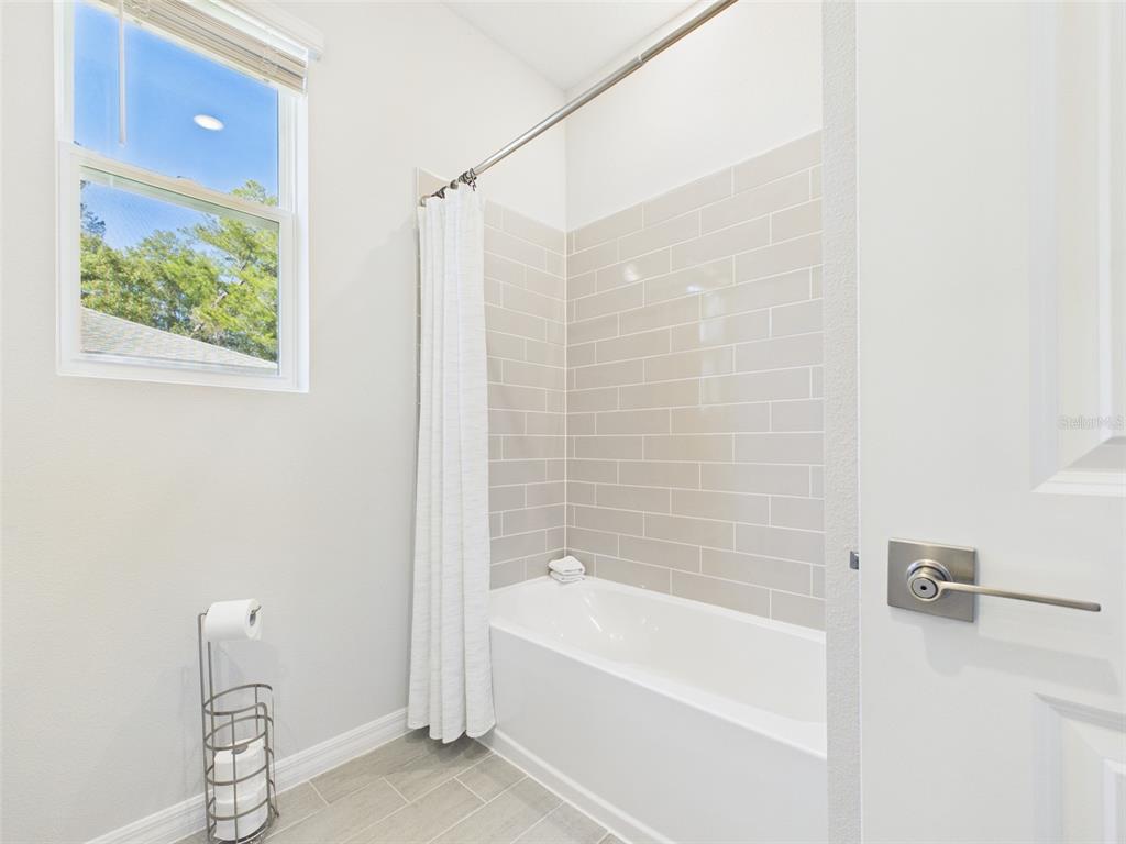 7110 Southwest 133rd Lane Ocala, FL 34473 - Photo 32 of 38 a bathroom with a bathtub and shower