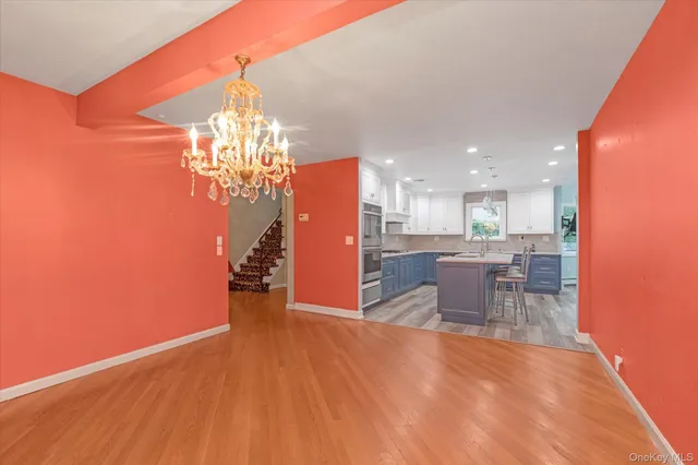 a view of a dining room with furniture and chandelier