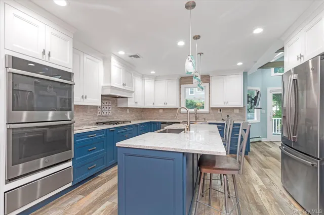 a kitchen with a sink stainless steel appliances and counter space