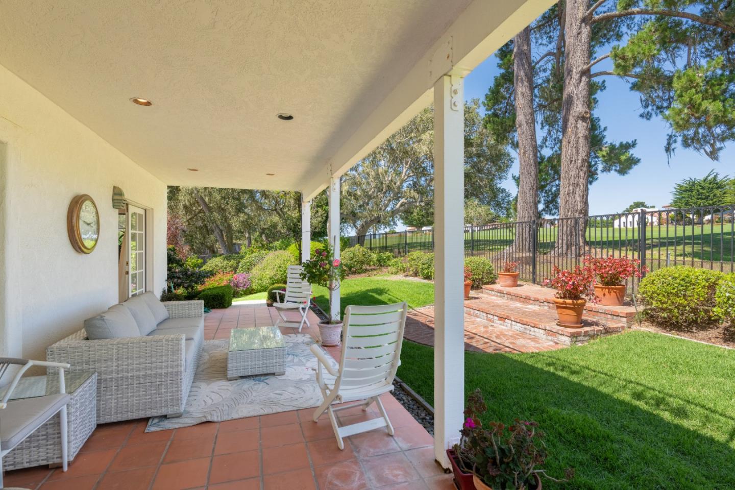 1043 Broncho Road Pebble Beach, CA 93953 - Photo 7 of 21 a view of a patio with couches potted plants and a big yard