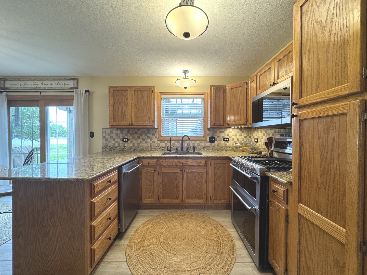 2041 Bluff Road South Kankakee, IL 60901 - Photo 10 of 39 a kitchen with stainless steel appliances granite countertop a stove a sink and a refrigerator