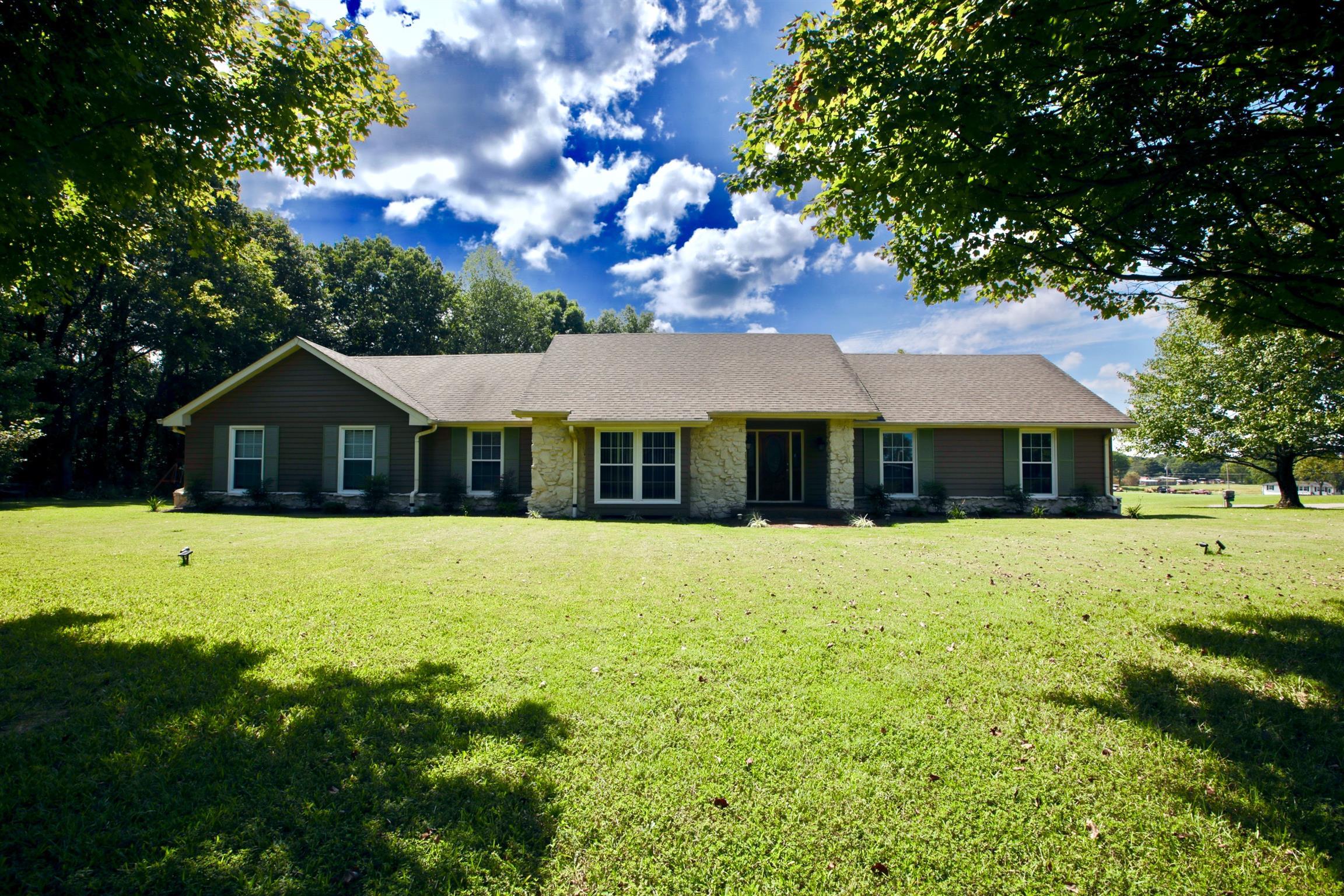 a front view of house with a garden