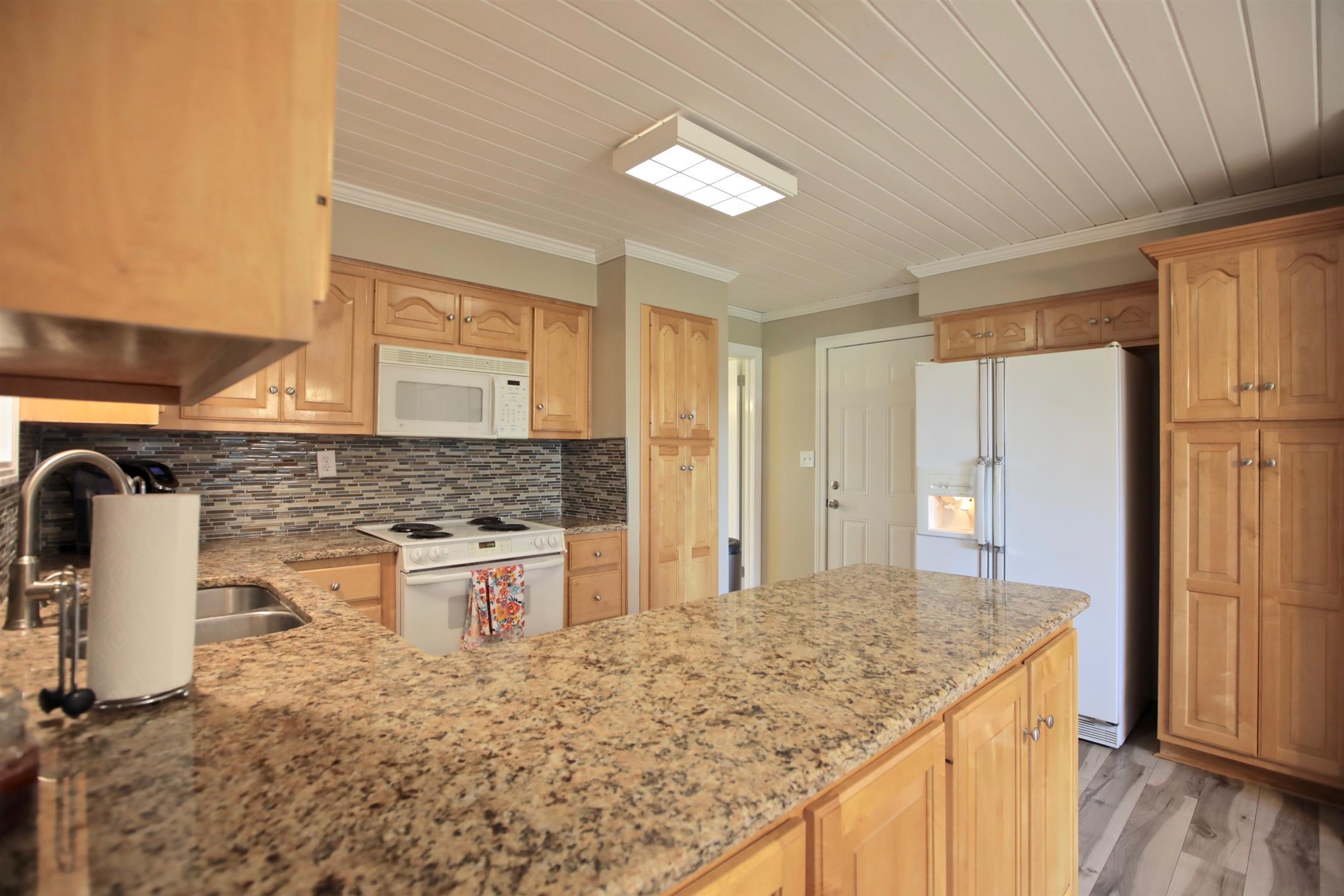 2674 New Hall Road Greenbrier, TN 37073 - Photo 12 of 30 a bathroom with a granite countertop sink and a mirror