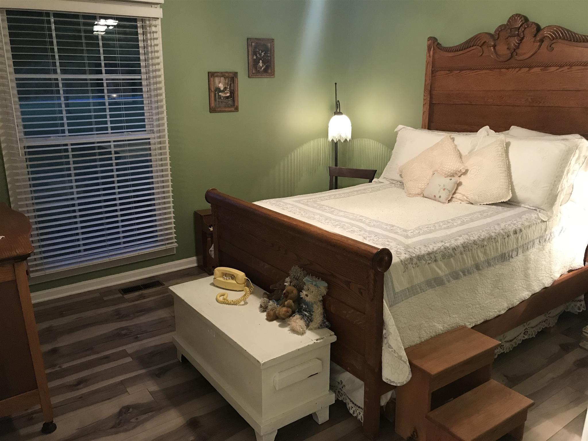 2674 New Hall Road Greenbrier, TN 37073 - Photo 20 of 30 a bedroom with a bed and a lamp on dresser