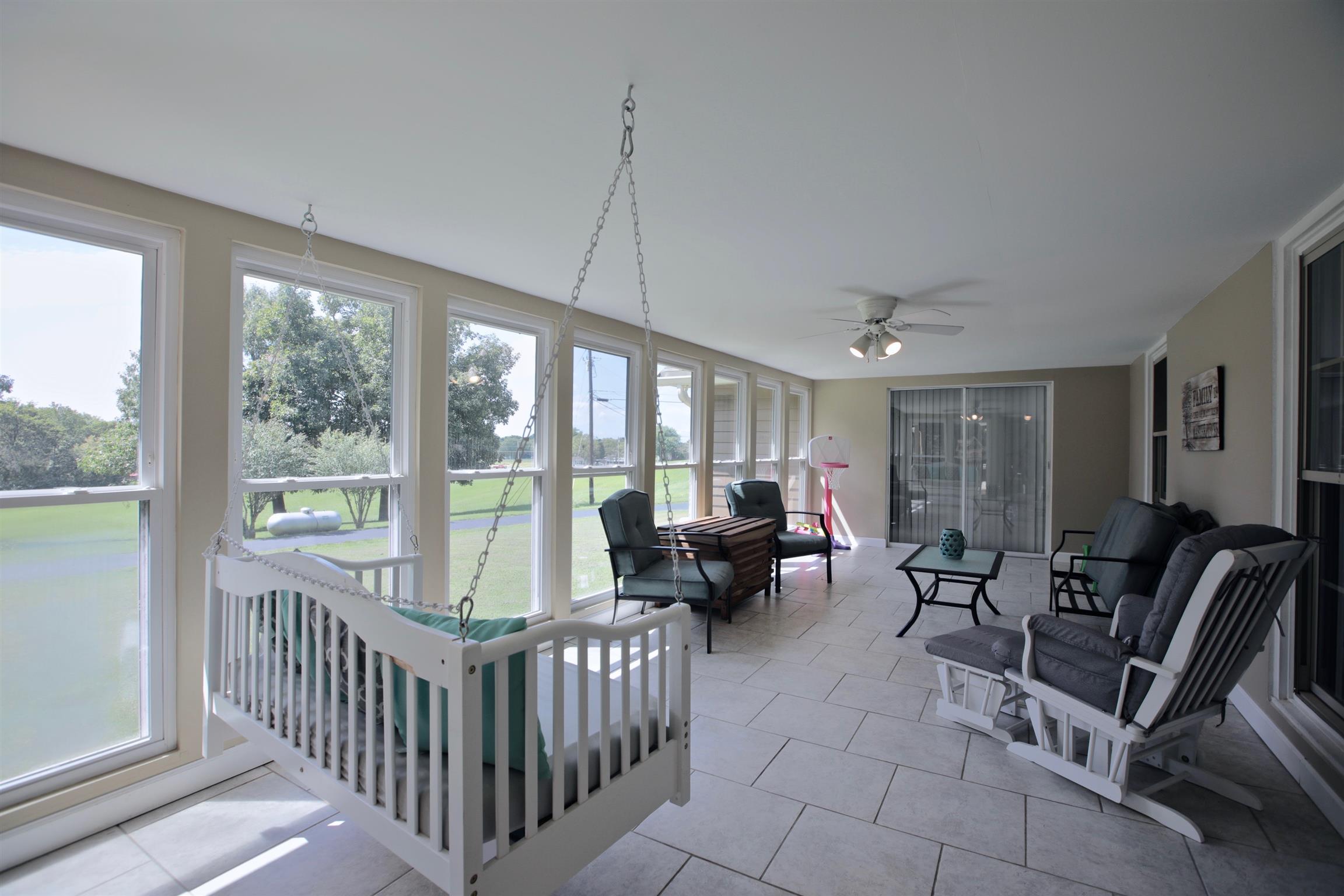 2674 New Hall Road Greenbrier, TN 37073 - Photo 22 of 30 a living room with furniture and floor to ceiling windows