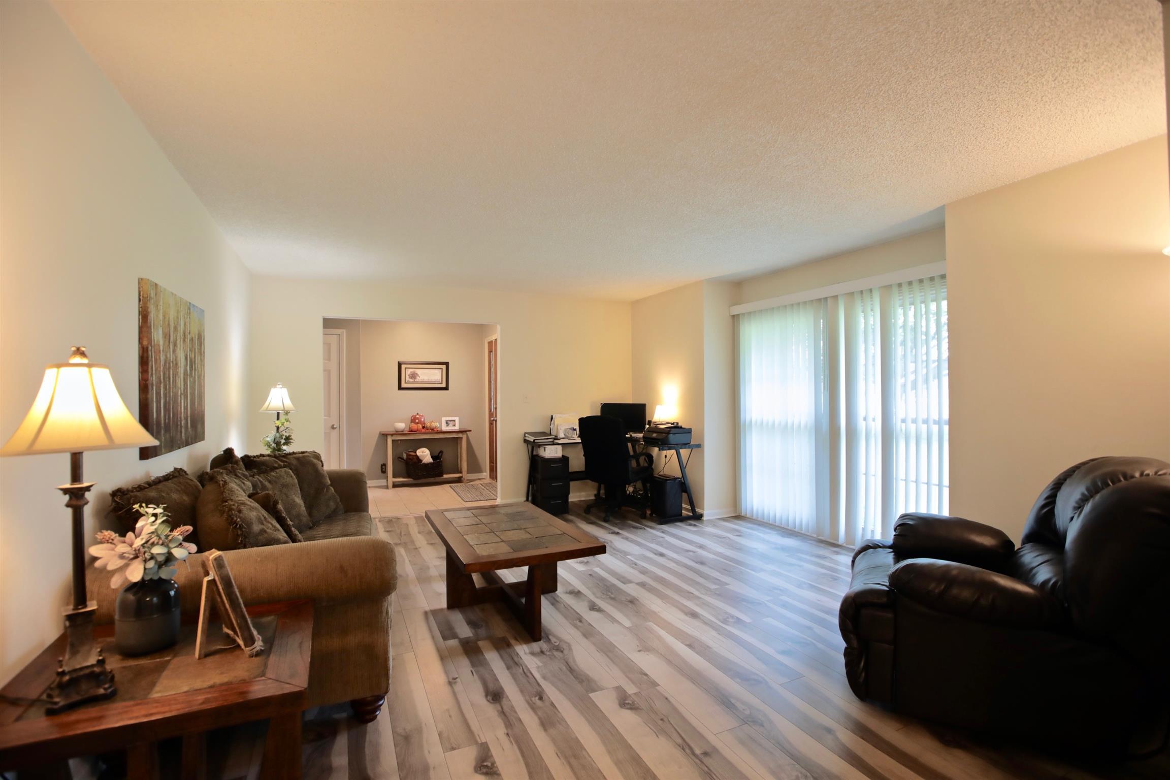 2674 New Hall Road Greenbrier, TN 37073 - Photo 7 of 30 a living room with furniture a lamp and a flat screen tv