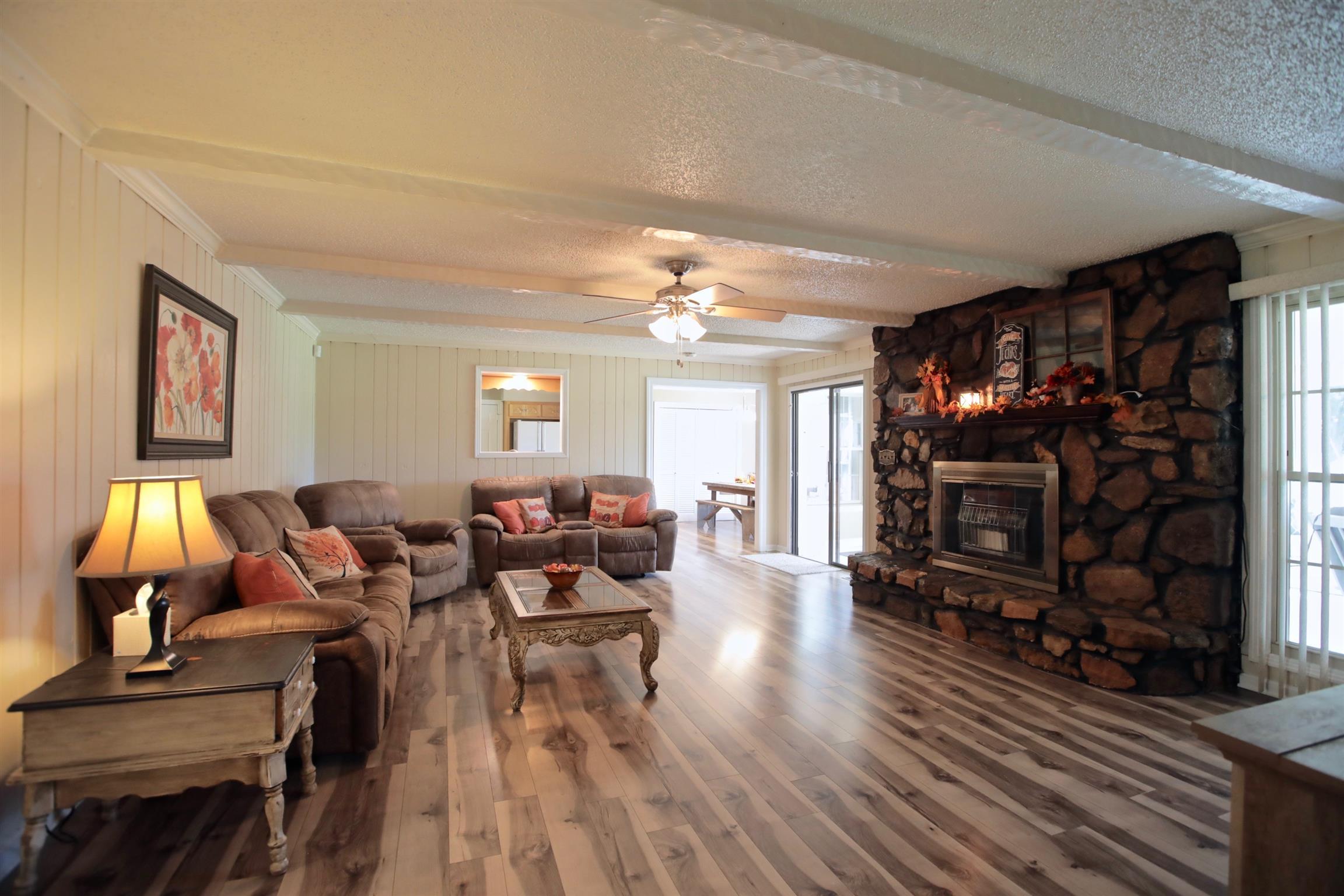 2674 New Hall Road Greenbrier, TN 37073 - Photo 9 of 30 a living room with furniture a rug and a fireplace