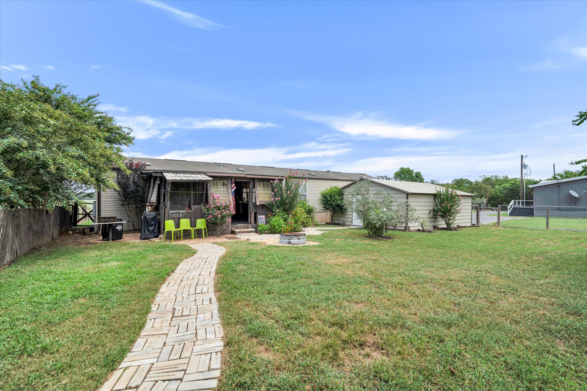 1500 Wattsville Road Luling, TX 78648 - Photo 21 of 38 Back of Guest House - A winding brick pathway leads through a spacious yard to this inviting home and adjacent outbuilding.