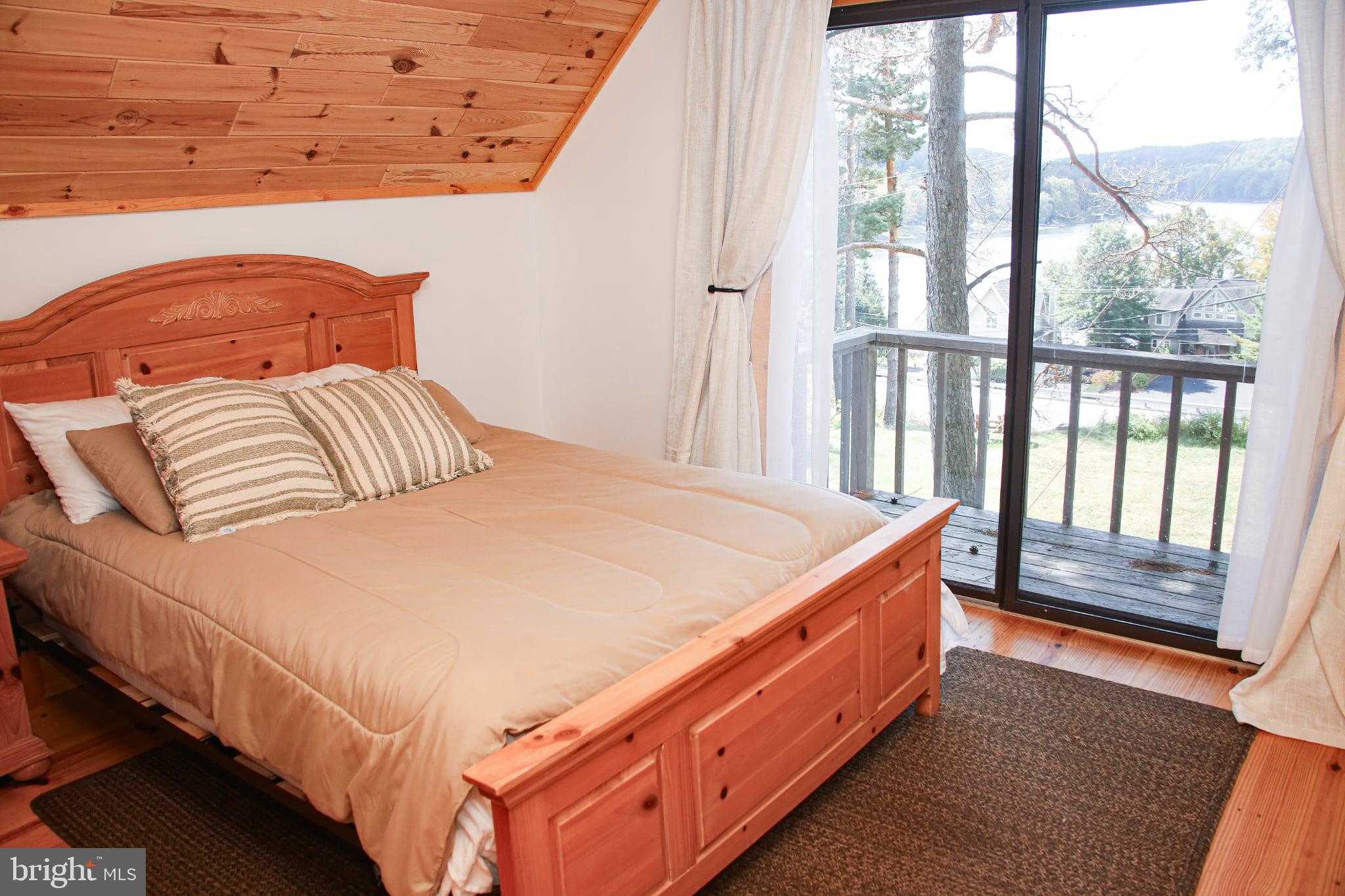 120 Rock Lodge Road McHenry, MD 21541 - Photo 10 of 23 Upstairs bedroom with balcony and lake views