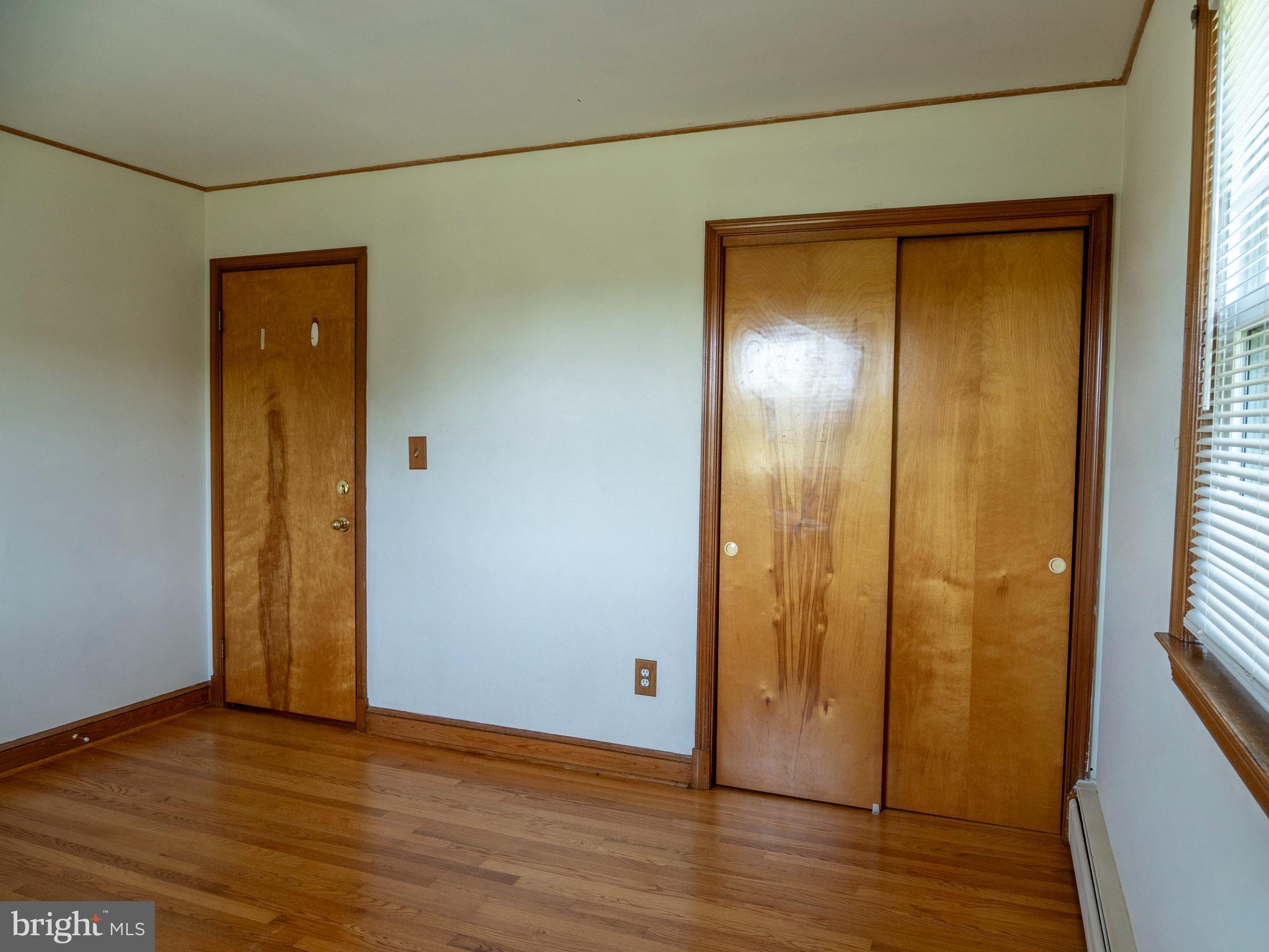26906 Clarksburg Road Damascus, MD 20872 - Photo 12 of 17 a view of an empty room with wooden floor and a window