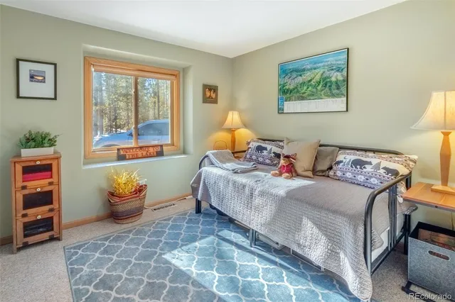 a bedroom with a bed and a couch