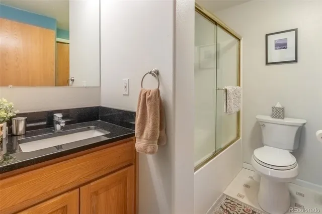 a bathroom with a toilet shower and a mirror