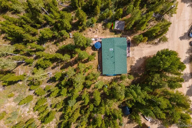 a view of a patio with a dining table and chairs with wooden floor