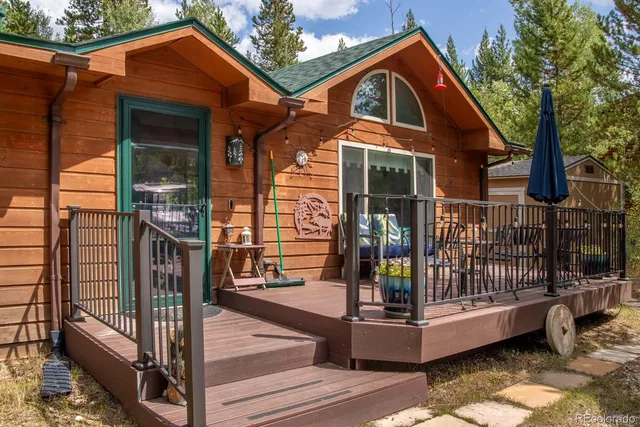 a wooden bench sitting in the backyard of a house
