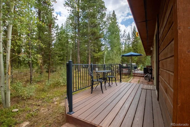 a view of balcony with chairs and wooden fence