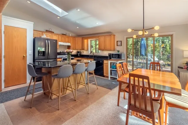a kitchen with stainless steel appliances granite countertop a stove a sink dishwasher and a refrigerator