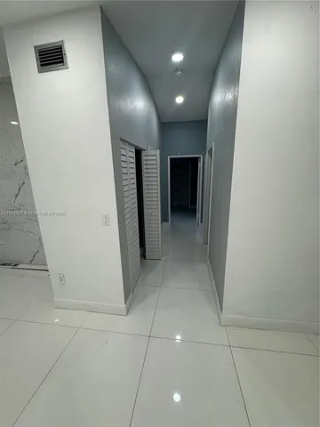 a view of hallway with a bathroom