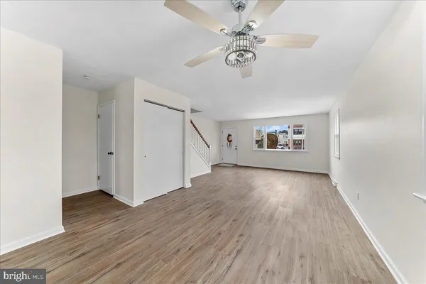 a kitchen with cabinets wooden floor and stainless steel appliances