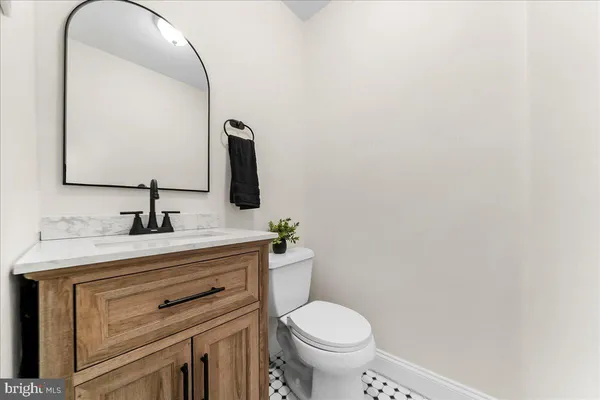 a bathroom with a sink a toilet and a mirror