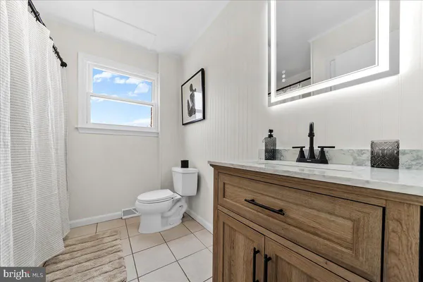 an empty room with fan and windows