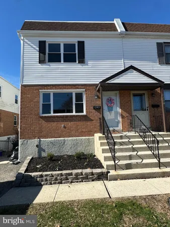 a front view of a house with stairs