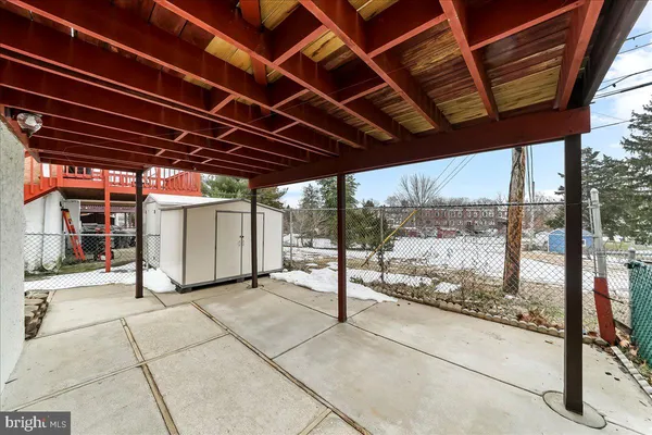 a picture of a bench in front of a wall