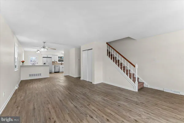 a view of a kitchen with wooden floor and a chandelier